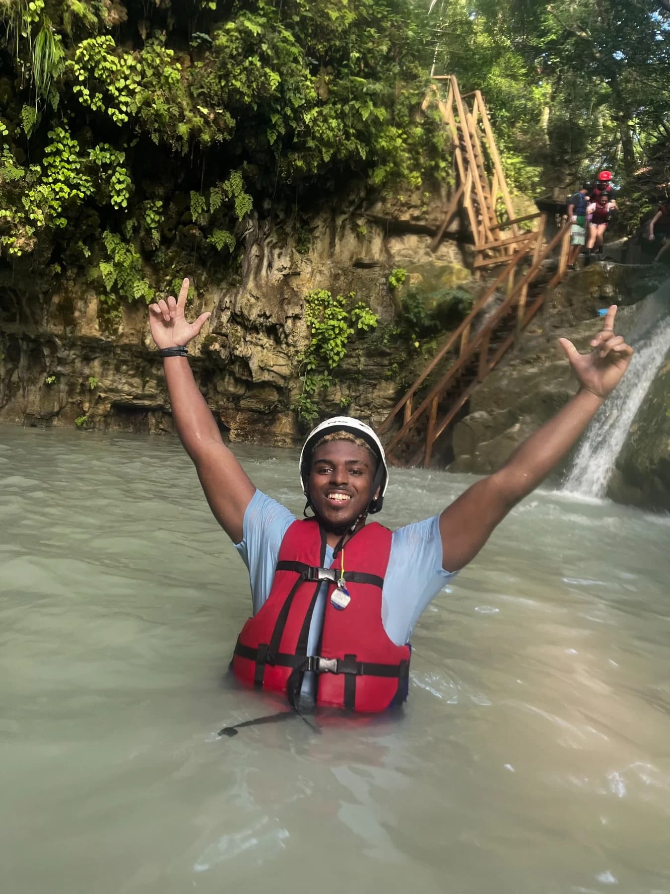 Standing in water near a waterfall